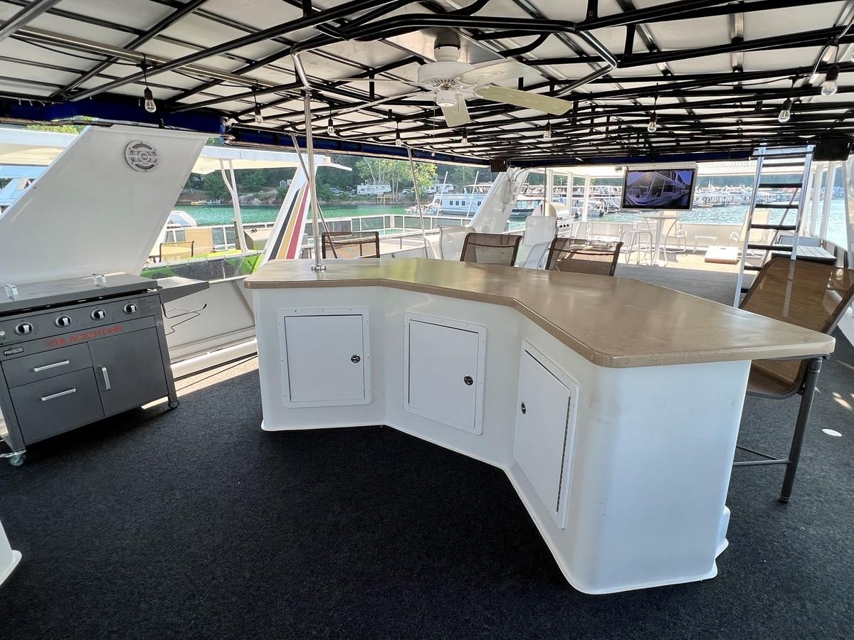 a room with a large table and cabinets aboard 2010/1995 STARDUST 20 X 95WB NLST Yacht for Sale