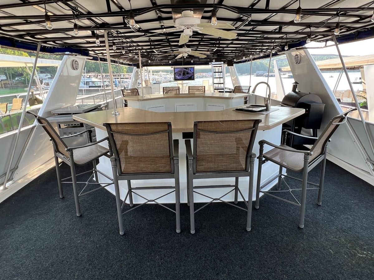 a table with chairs and a machine aboard 2010/1995 STARDUST 20 X 95WB NLST Yacht for Sale