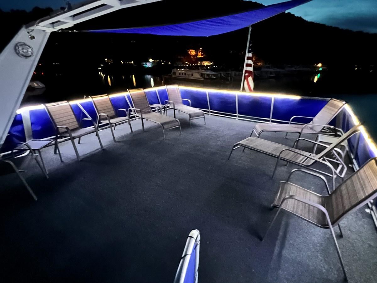 a pool with chairs and a table aboard 2010/1995 STARDUST 20 X 95WB NLST Yacht for Sale