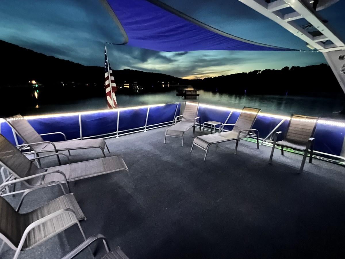 a pool with chairs and a hammock aboard 2010/1995 STARDUST 20 X 95WB NLST Yacht for Sale