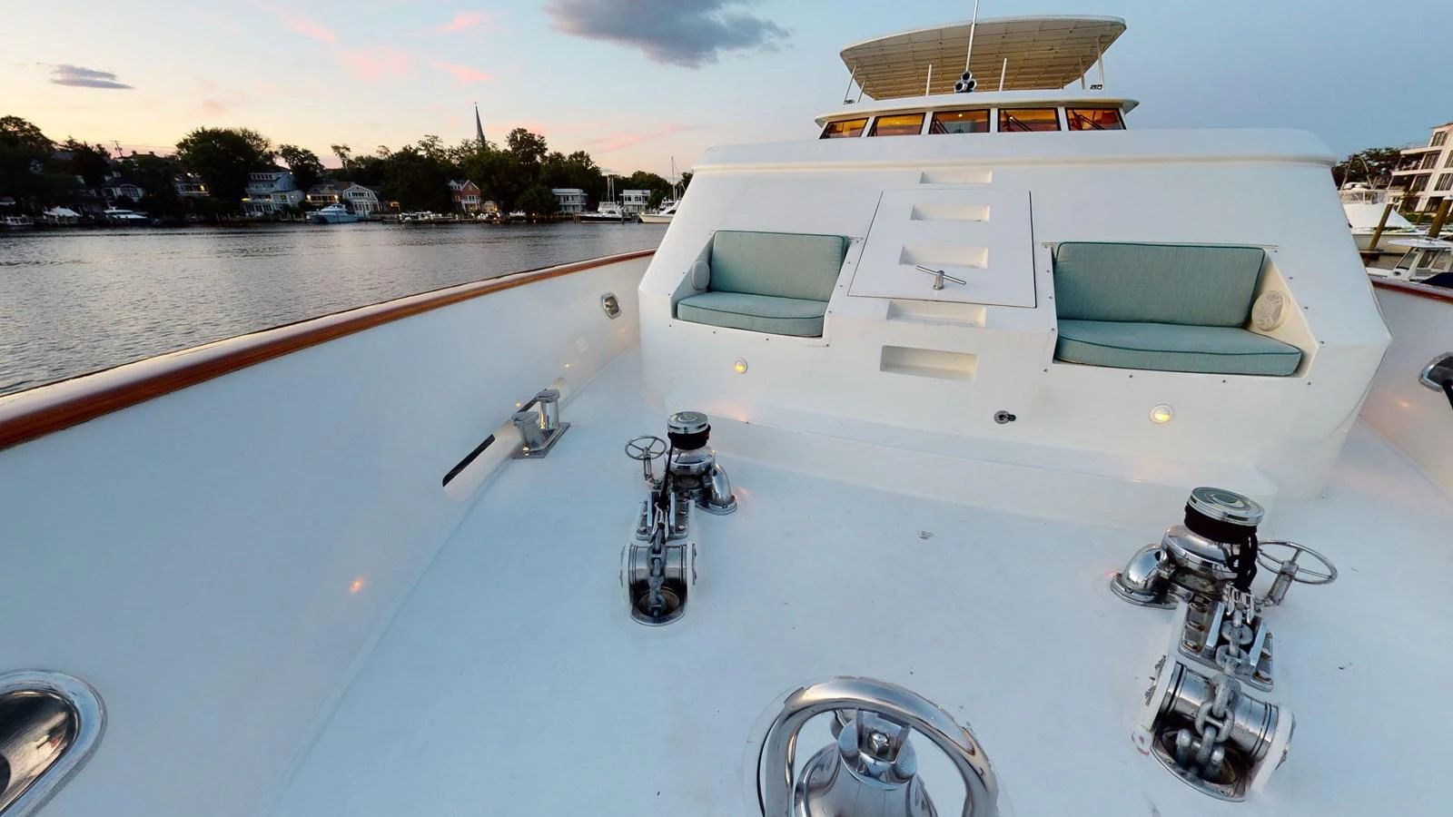 a white building with a balcony and a couple of motorcycles parked on the side of it aboard SUMMER LOVE Yacht for Sale