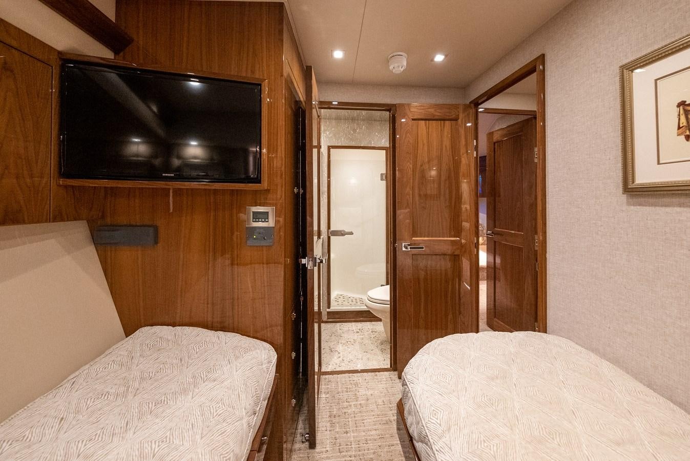 a bedroom with a bed and a television aboard ANOTHER DAY IN PARADISE Yacht for Sale