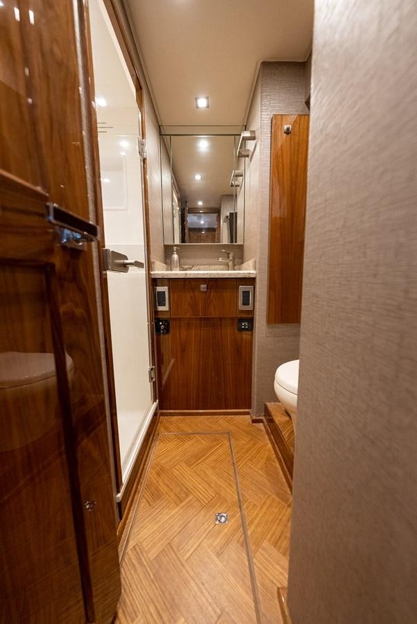 a bathroom with a wood door aboard ANOTHER DAY IN PARADISE Yacht for Sale