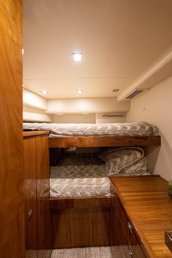 a room with a bed and a desk aboard ANOTHER DAY IN PARADISE Yacht for Sale