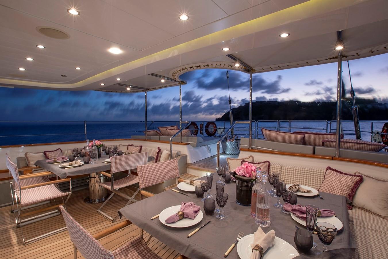 a room with tables and chairs aboard MARE NOSTRUM Yacht for Charter