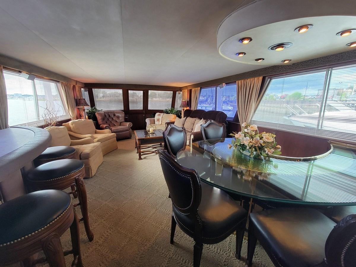 a large living room with a large table and chairs aboard LADY PATRICIA Yacht for Sale