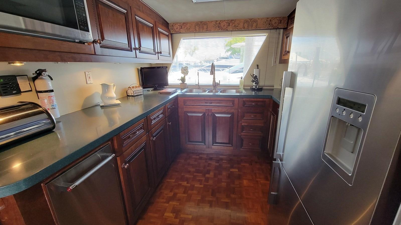a kitchen with wooden cabinets aboard LADY PATRICIA Yacht for Sale