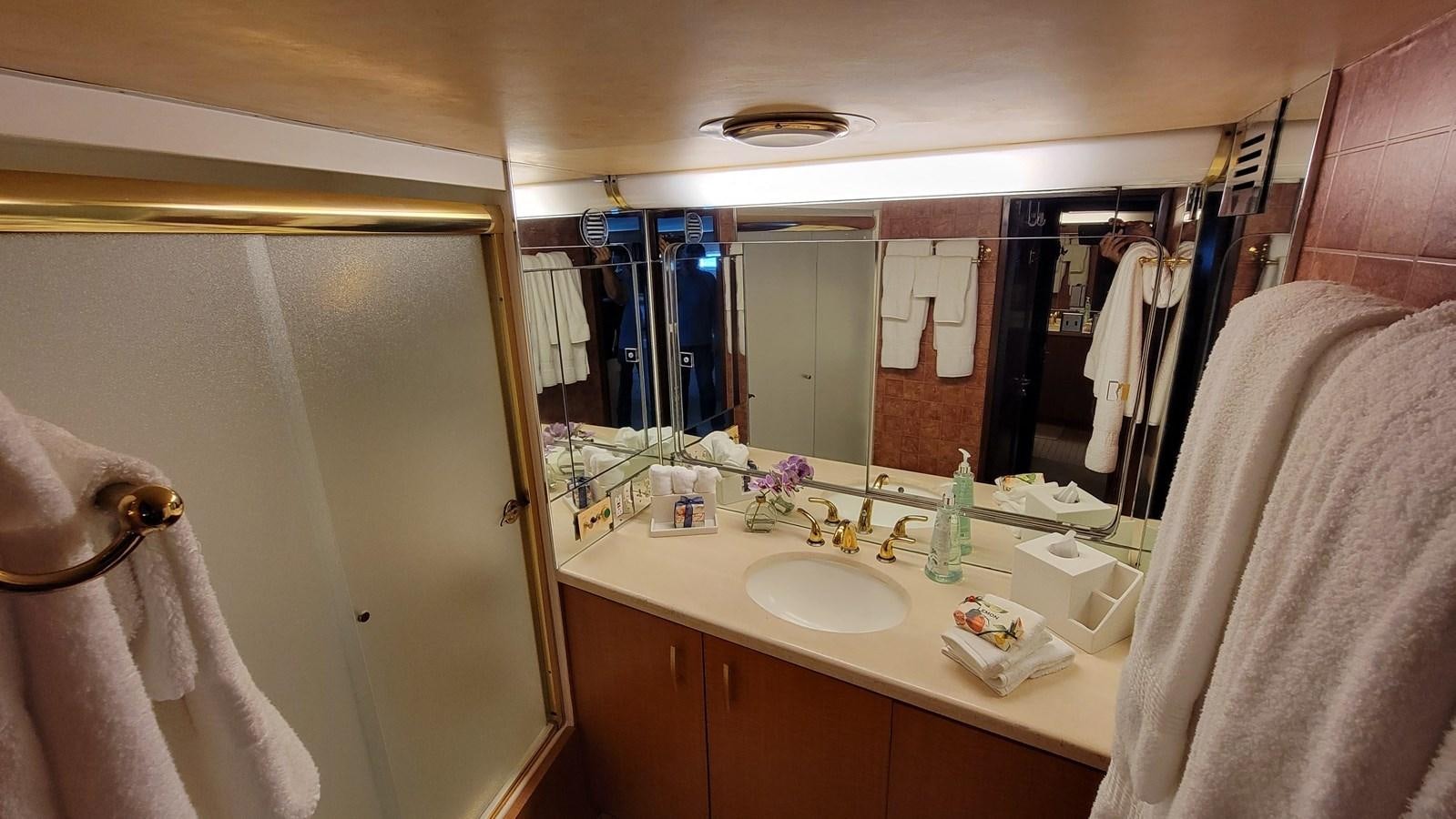 a bathroom with a large mirror aboard LADY PATRICIA Yacht for Sale