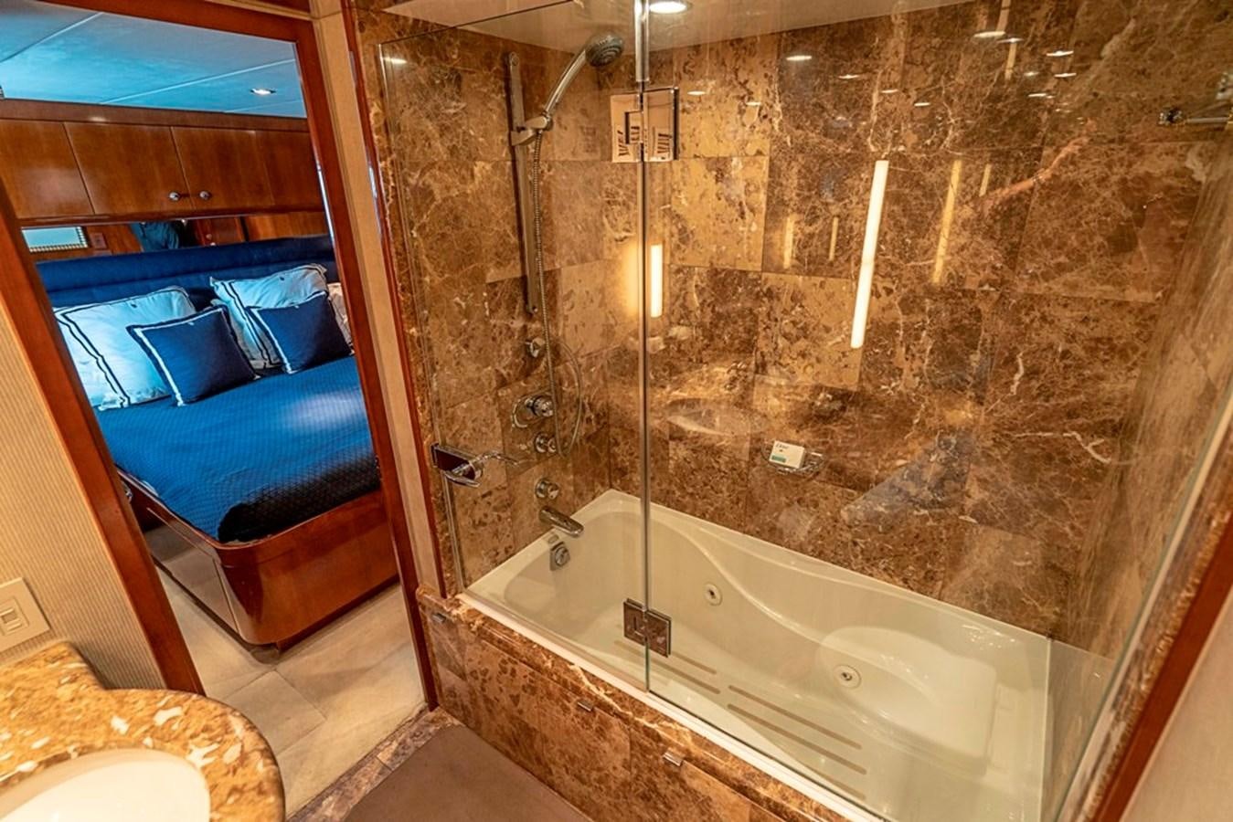 a bathroom with a glass shower aboard PURA VIDA Yacht for Sale