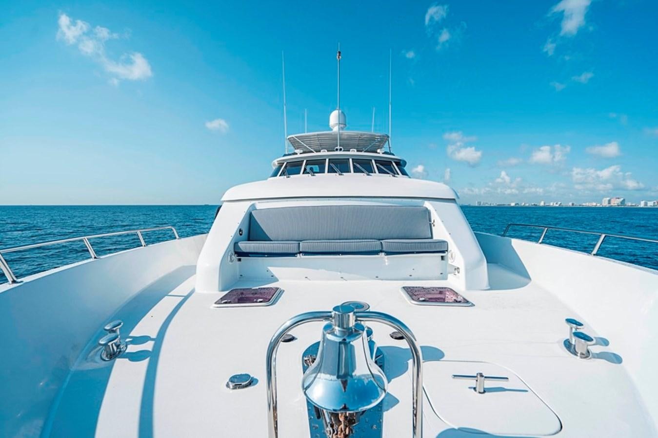 a white yacht on a body of water aboard PURA VIDA Yacht for Sale