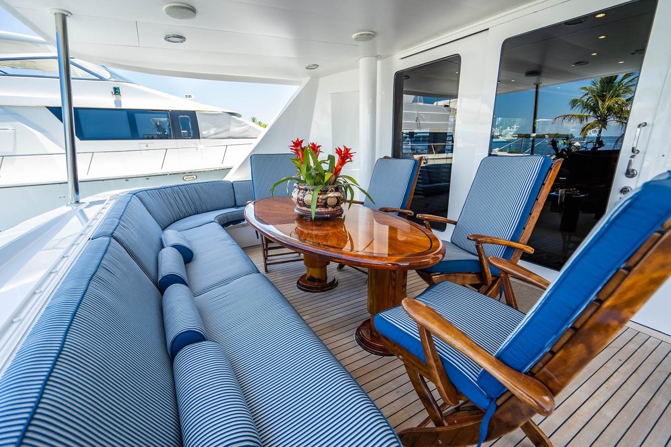 a boat with a table and chairs aboard PURA VIDA Yacht for Sale