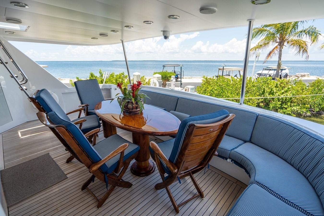a table and chairs on a balcony aboard PURA VIDA Yacht for Sale