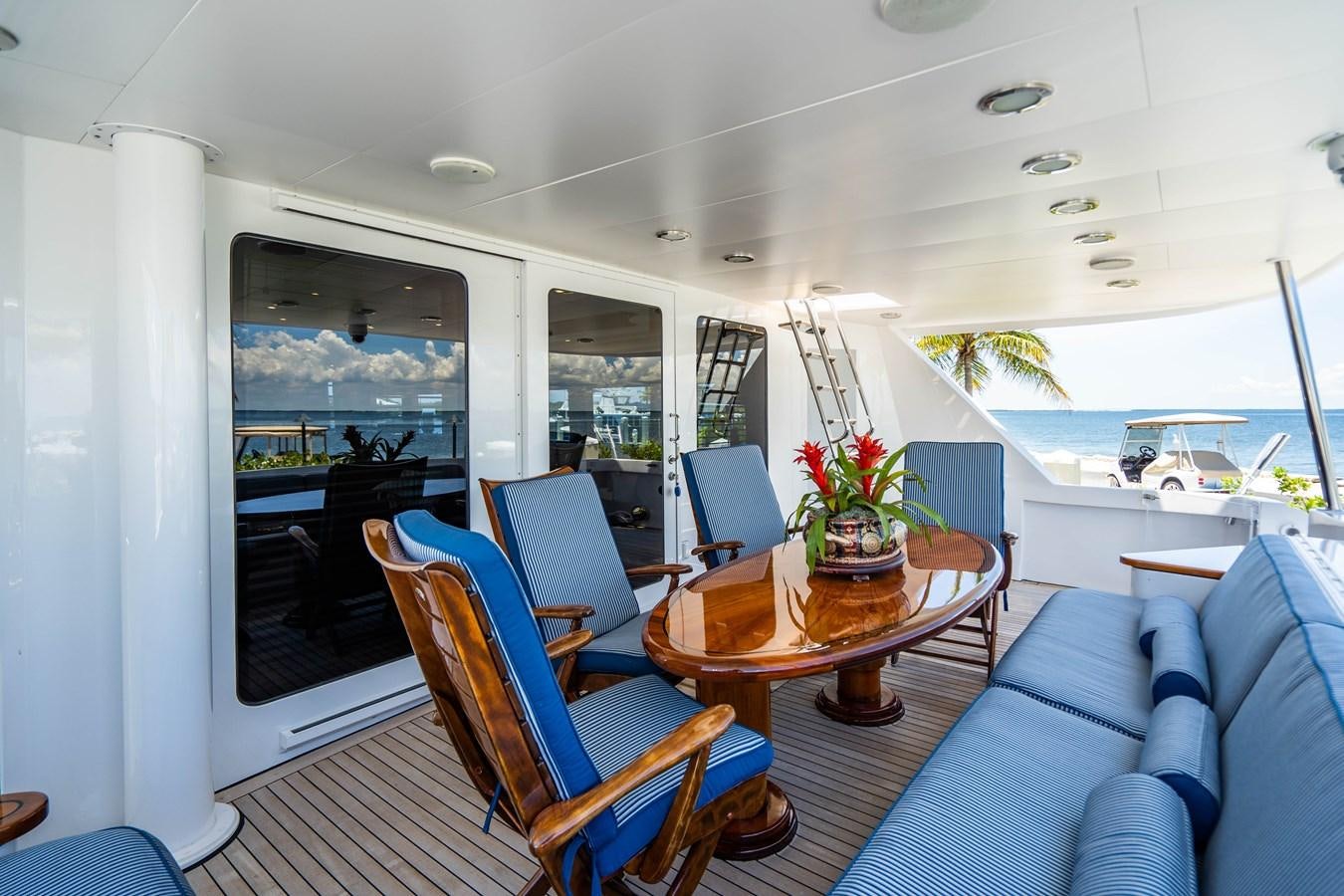a boat with a table and chairs aboard PURA VIDA Yacht for Sale