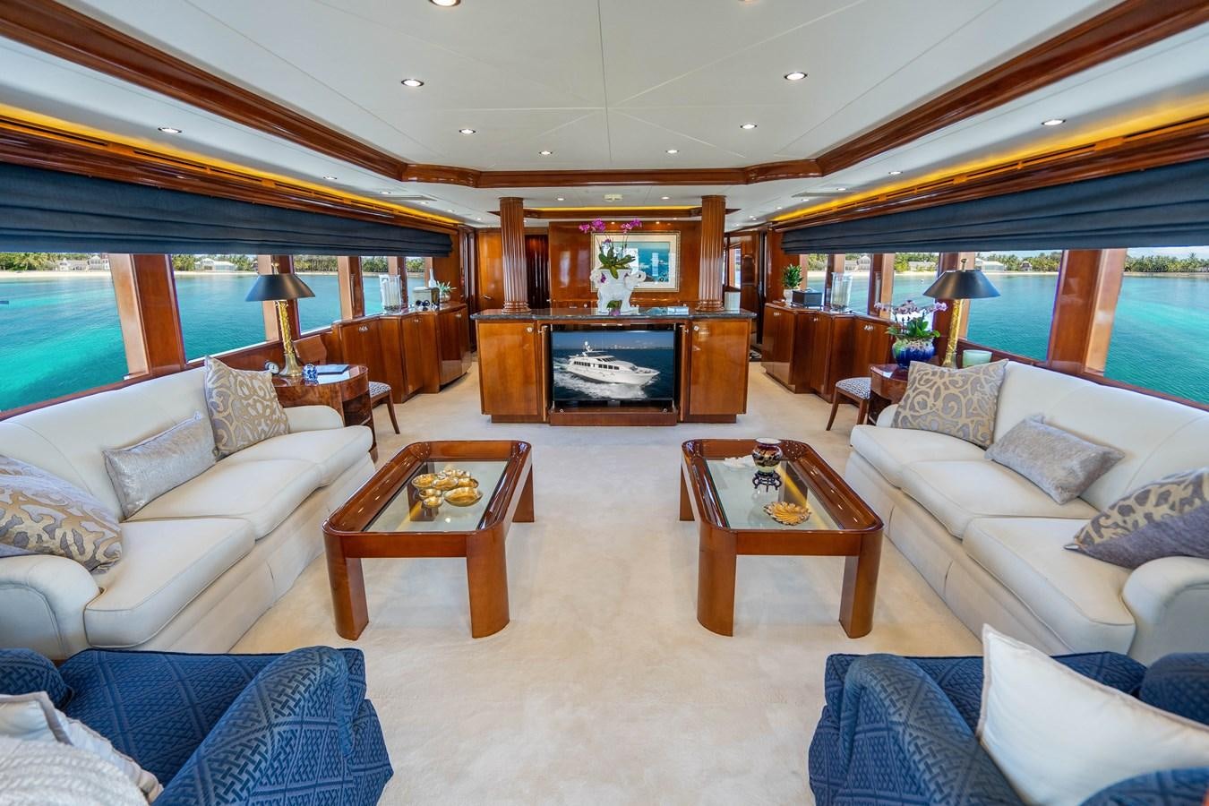 a living room with a fireplace aboard PURA VIDA Yacht for Sale