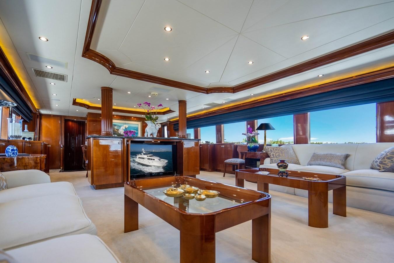 a living room with a large screen aboard PURA VIDA Yacht for Sale