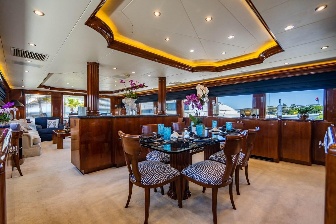 a large kitchen with a table and chairs aboard PURA VIDA Yacht for Sale
