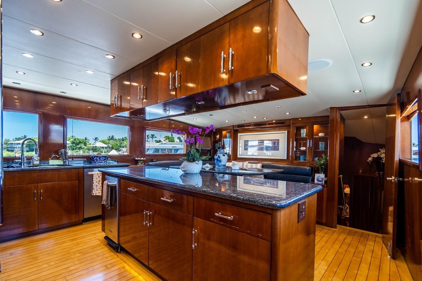 a kitchen with wooden cabinets aboard PURA VIDA Yacht for Sale