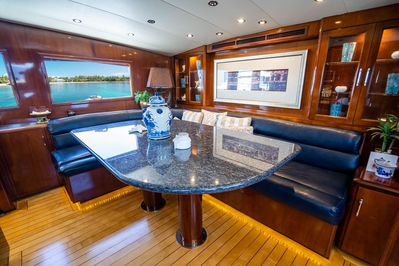 a living room with a table and couches aboard PURA VIDA Yacht for Sale