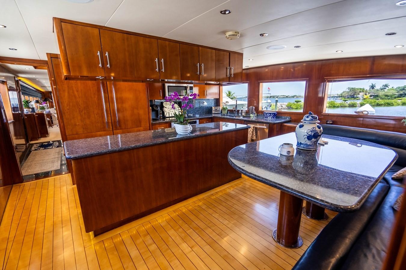 a kitchen with wooden cabinets aboard PURA VIDA Yacht for Sale