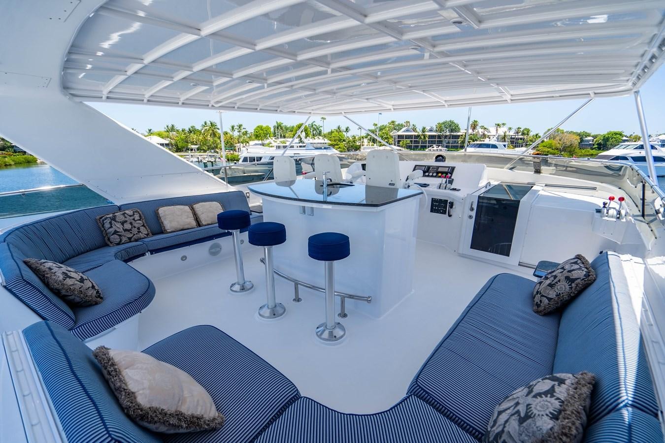 a boat with a table and chairs aboard PURA VIDA Yacht for Sale