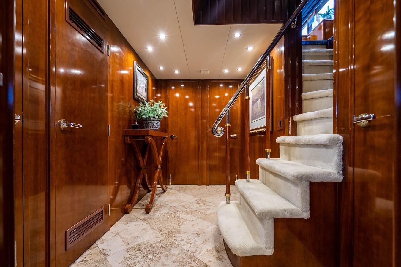 a room with wooden walls and a staircase aboard PURA VIDA Yacht for Sale