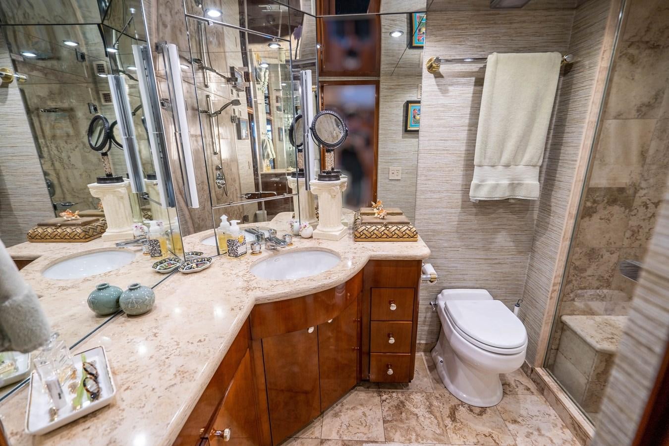a bathroom with a sink toilet and a mirror aboard PURA VIDA Yacht for Sale
