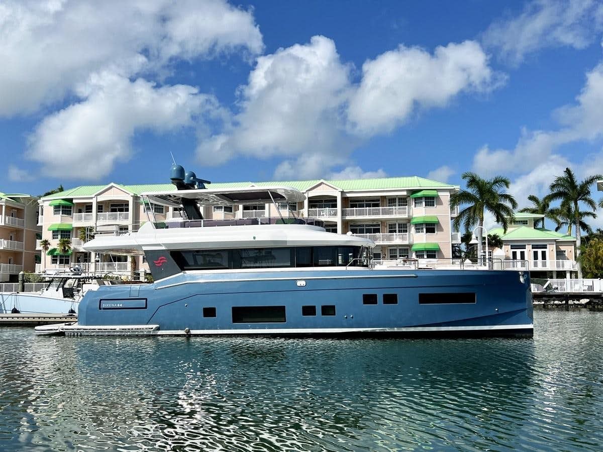 a large white boat in a harbor aboard SIRENA 64 FLYBRIDGE Yacht for Sale