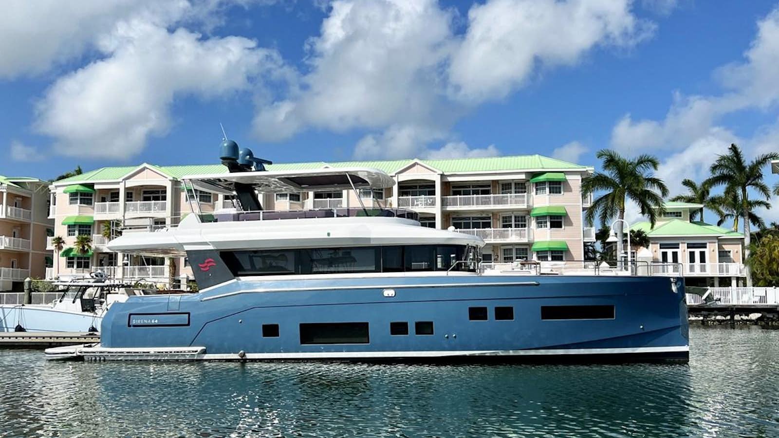 a large white boat in a harbor aboard SIRENA 64 FLYBRIDGE Yacht for Sale