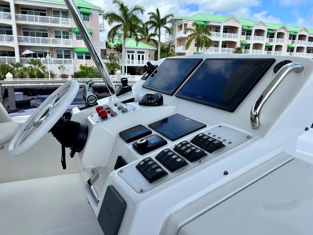 a white car with a black hood aboard SIRENA 64 FLYBRIDGE Yacht for Sale