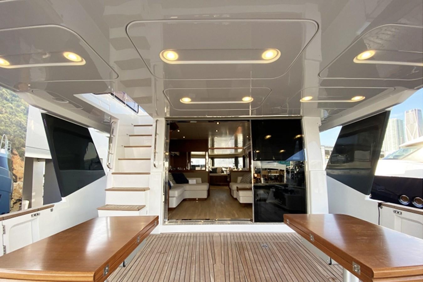 a room with a table and a tv aboard SIRENA 64 FLYBRIDGE Yacht for Sale