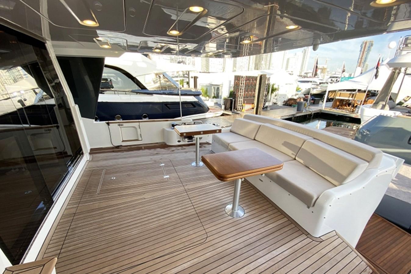 a room with a table and chairs aboard SIRENA 64 FLYBRIDGE Yacht for Sale