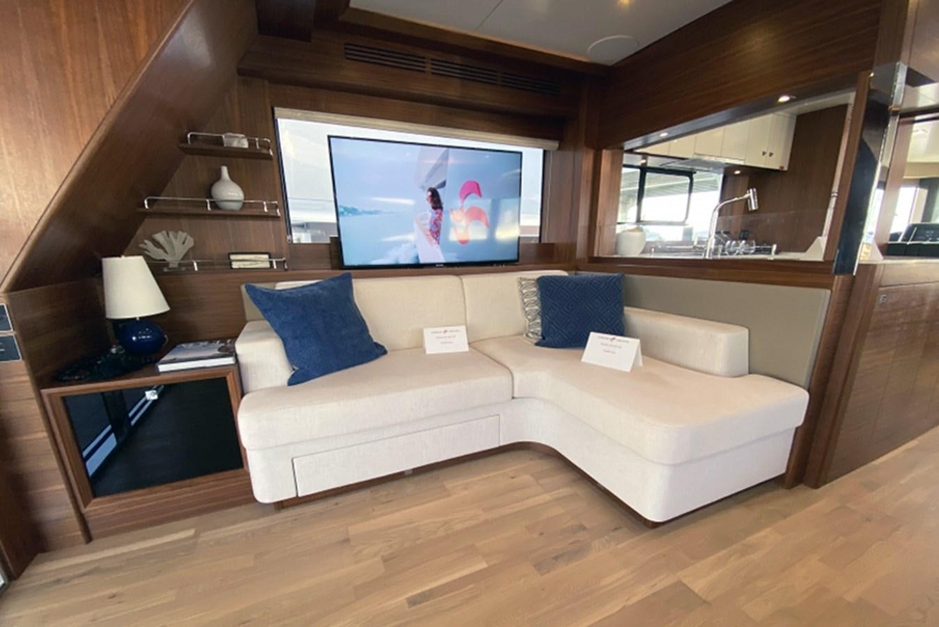 a living room with a large screen aboard SIRENA 64 FLYBRIDGE Yacht for Sale