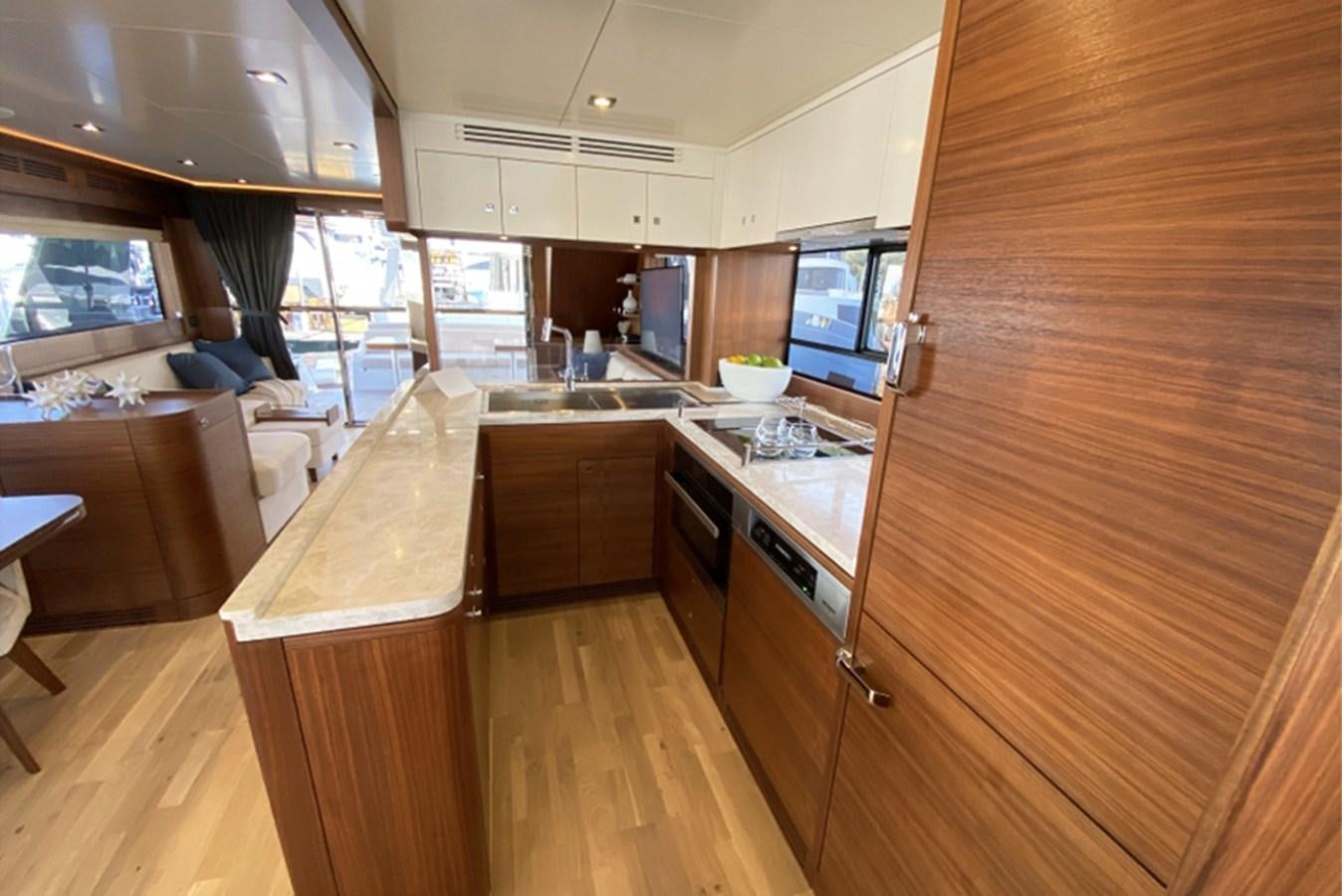 a kitchen with wooden cabinets aboard SIRENA 64 FLYBRIDGE Yacht for Sale