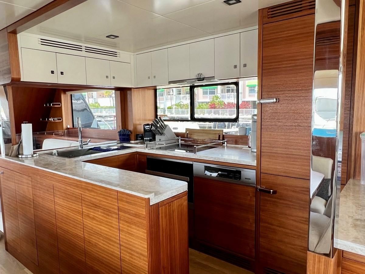 a kitchen with a large glass door aboard SIRENA 64 FLYBRIDGE Yacht for Sale