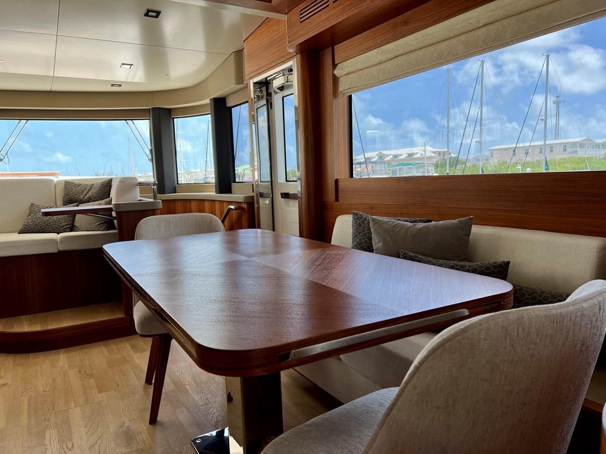a table and chairs in a room aboard SIRENA 64 FLYBRIDGE Yacht for Sale