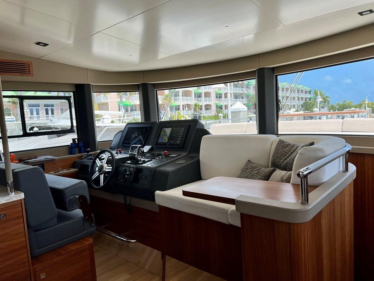 a living room with a couch and a desk aboard SIRENA 64 FLYBRIDGE Yacht for Sale