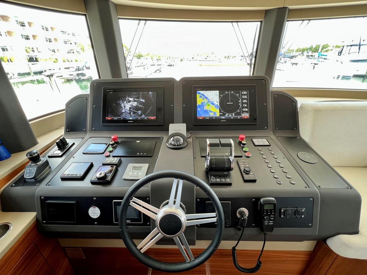a table with electronic devices aboard SIRENA 64 FLYBRIDGE Yacht for Sale