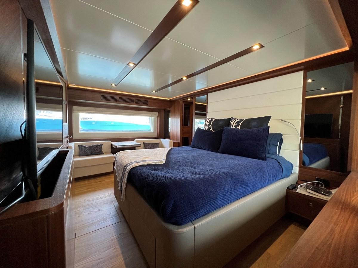 a bedroom with a bed and a tv aboard SIRENA 64 FLYBRIDGE Yacht for Sale