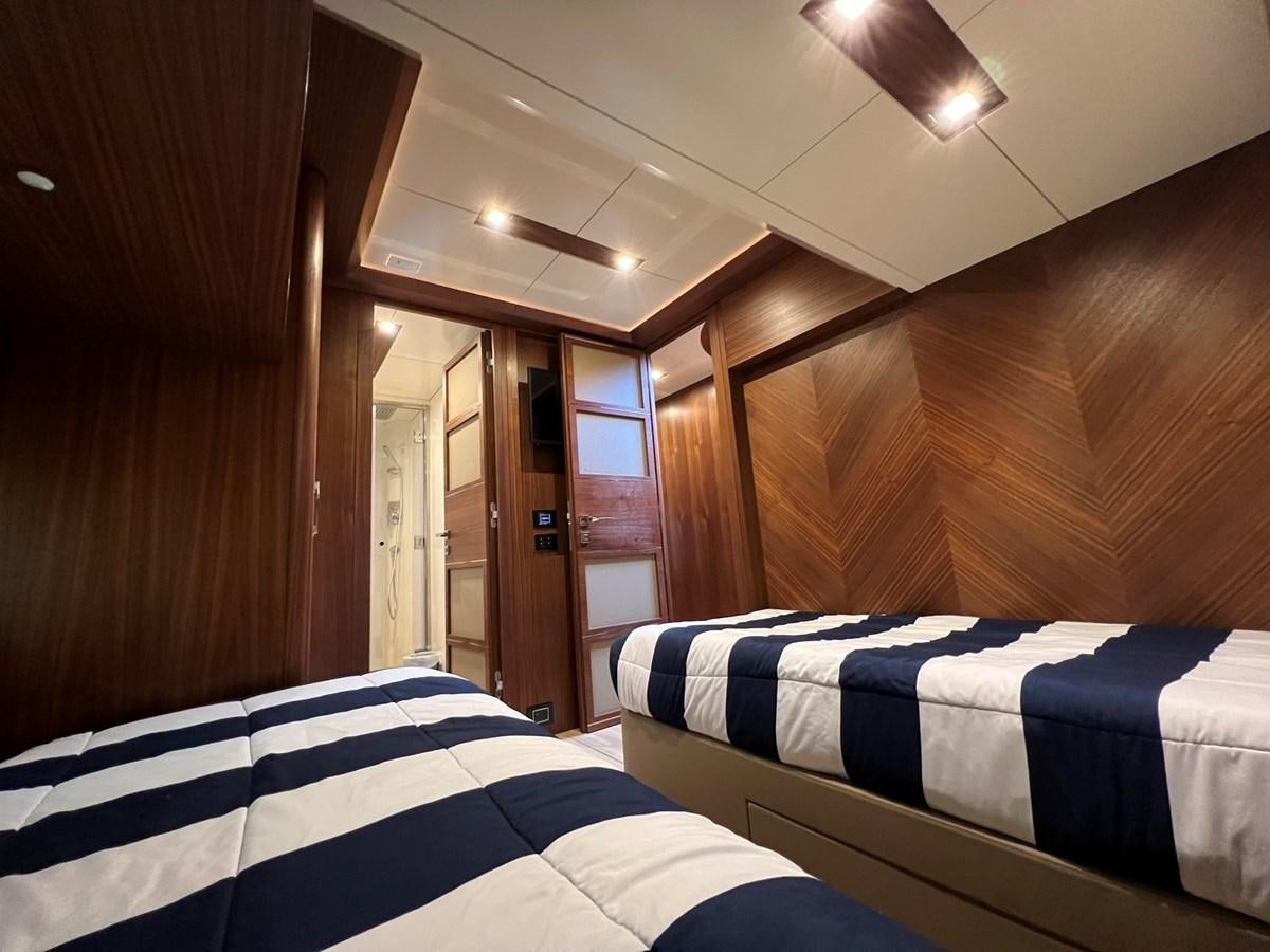 a room with bunk beds aboard SIRENA 64 FLYBRIDGE Yacht for Sale