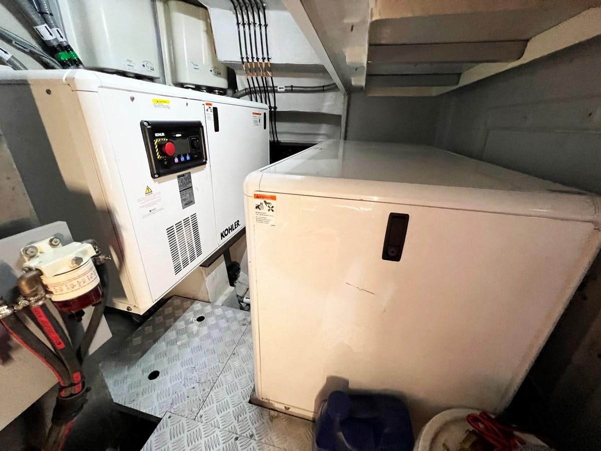 a large white machine aboard SIRENA 64 FLYBRIDGE Yacht for Sale