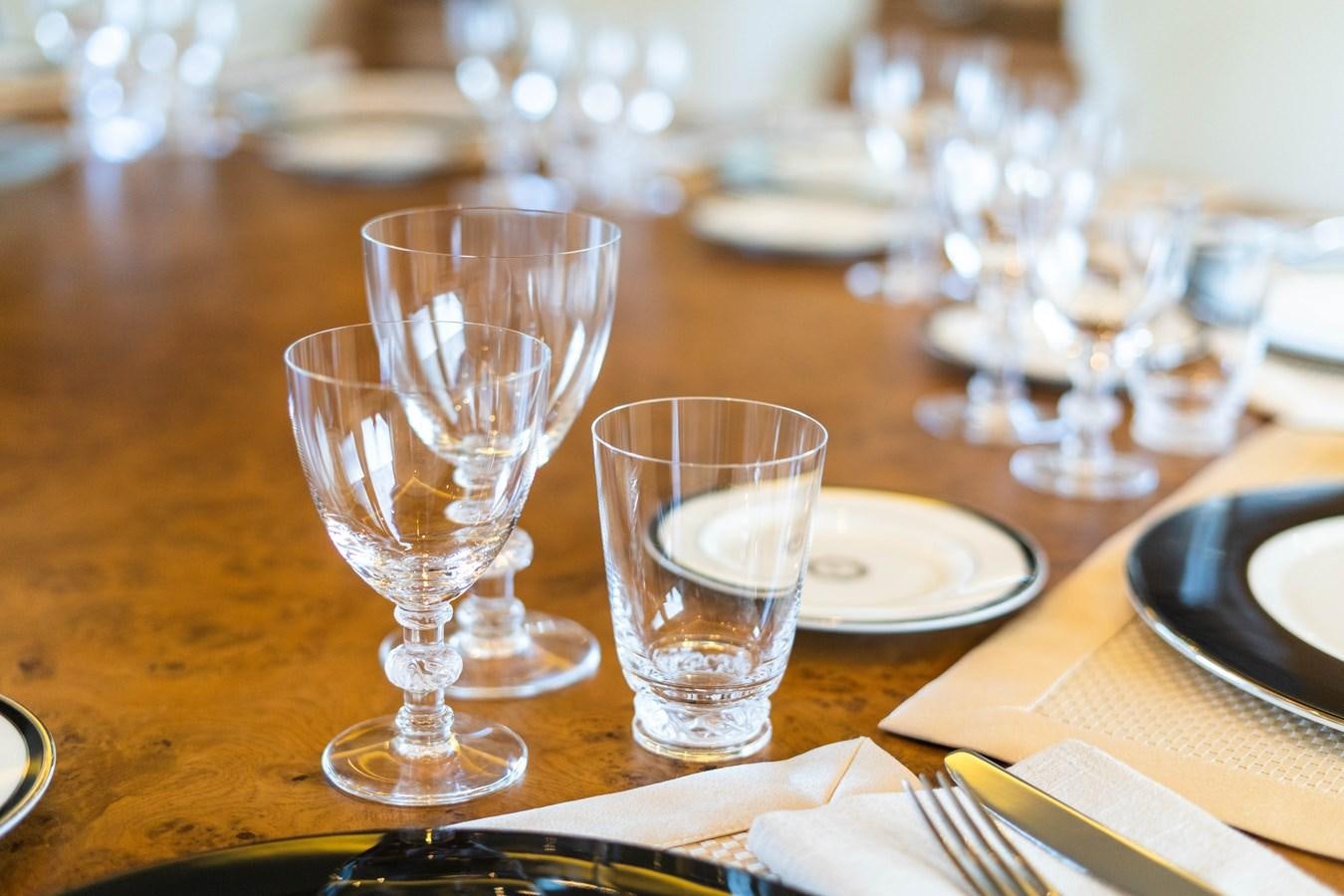 a table with empty wine glasses aboard ARTEMISEA Yacht for Charter