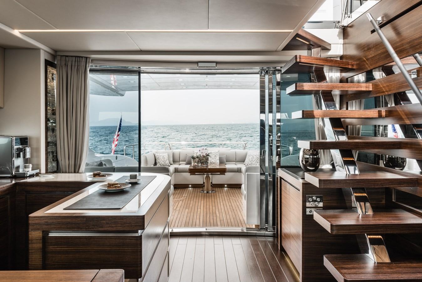 a room with a view of the ocean and a balcony aboard MINE SET Yacht for Sale