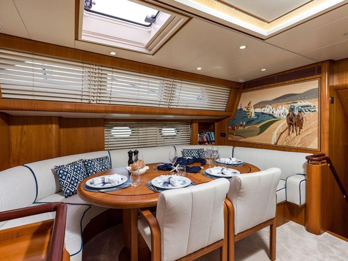 a dining table in a room aboard CHARLATAN Yacht for Sale