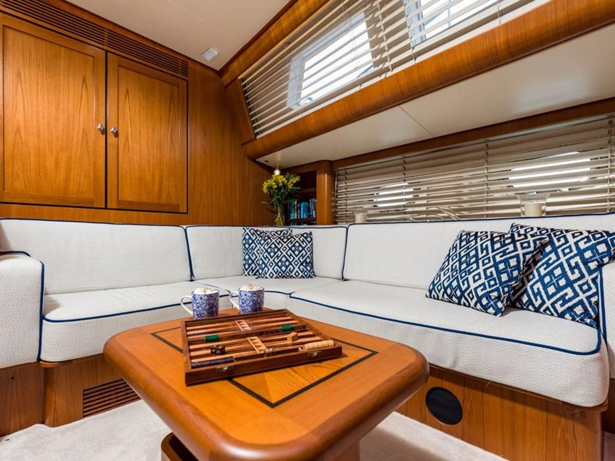 a living room with a couch and a table aboard CHARLATAN Yacht for Sale