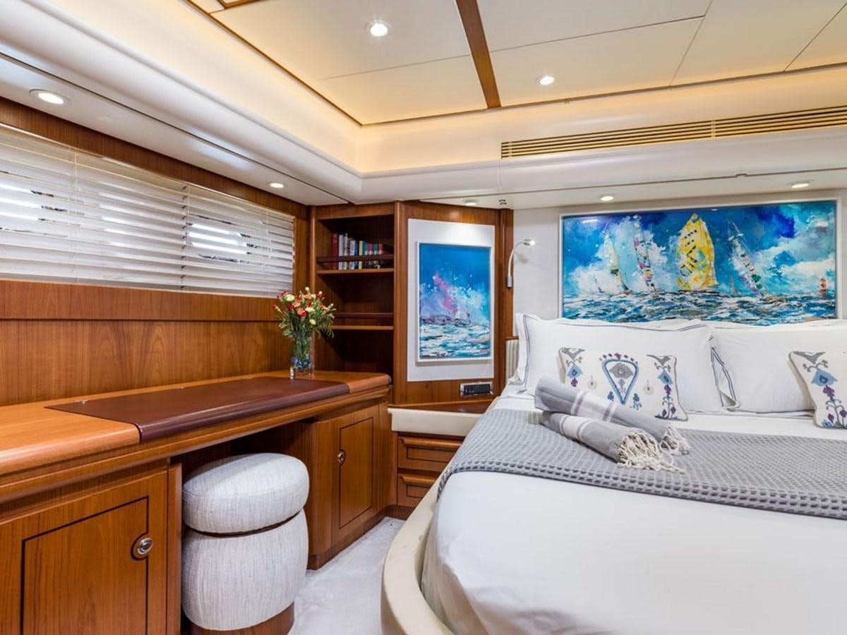 a room with a bed and a desk aboard CHARLATAN Yacht for Sale