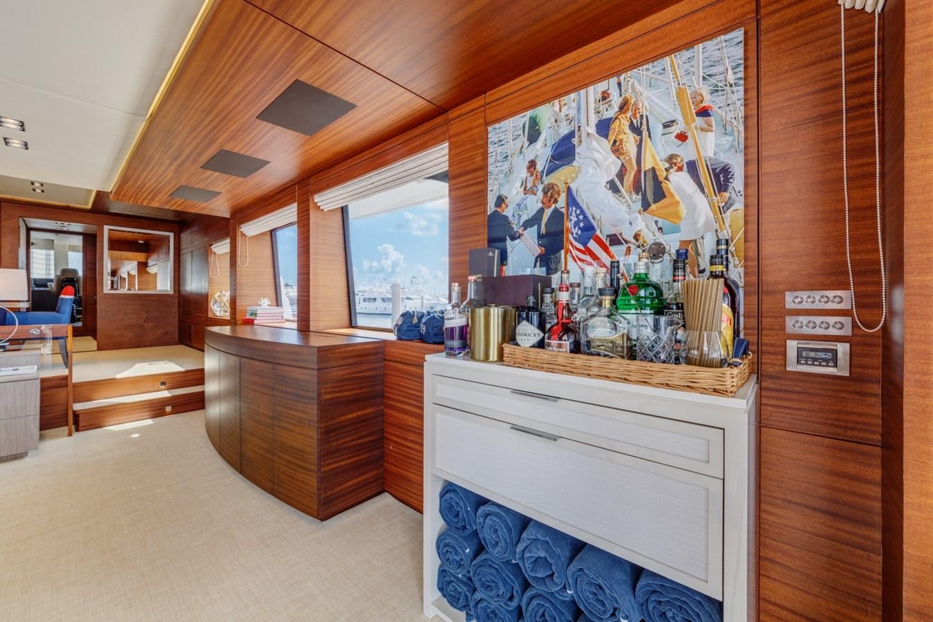 a room with a desk and a large painting on the wall aboard PRIMA MEA Yacht for Sale