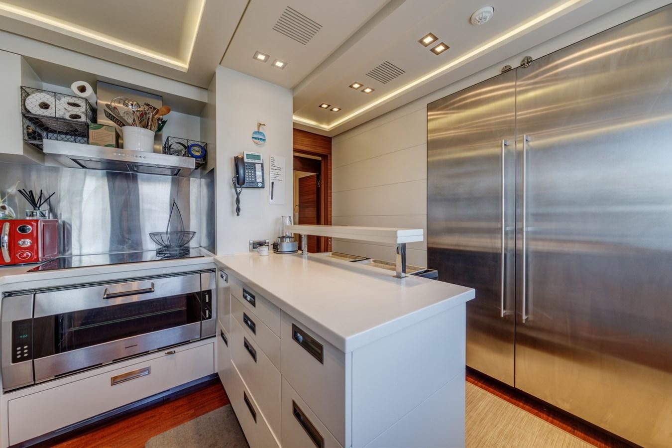 a kitchen with stainless steel appliances aboard PRIMA MEA Yacht for Sale