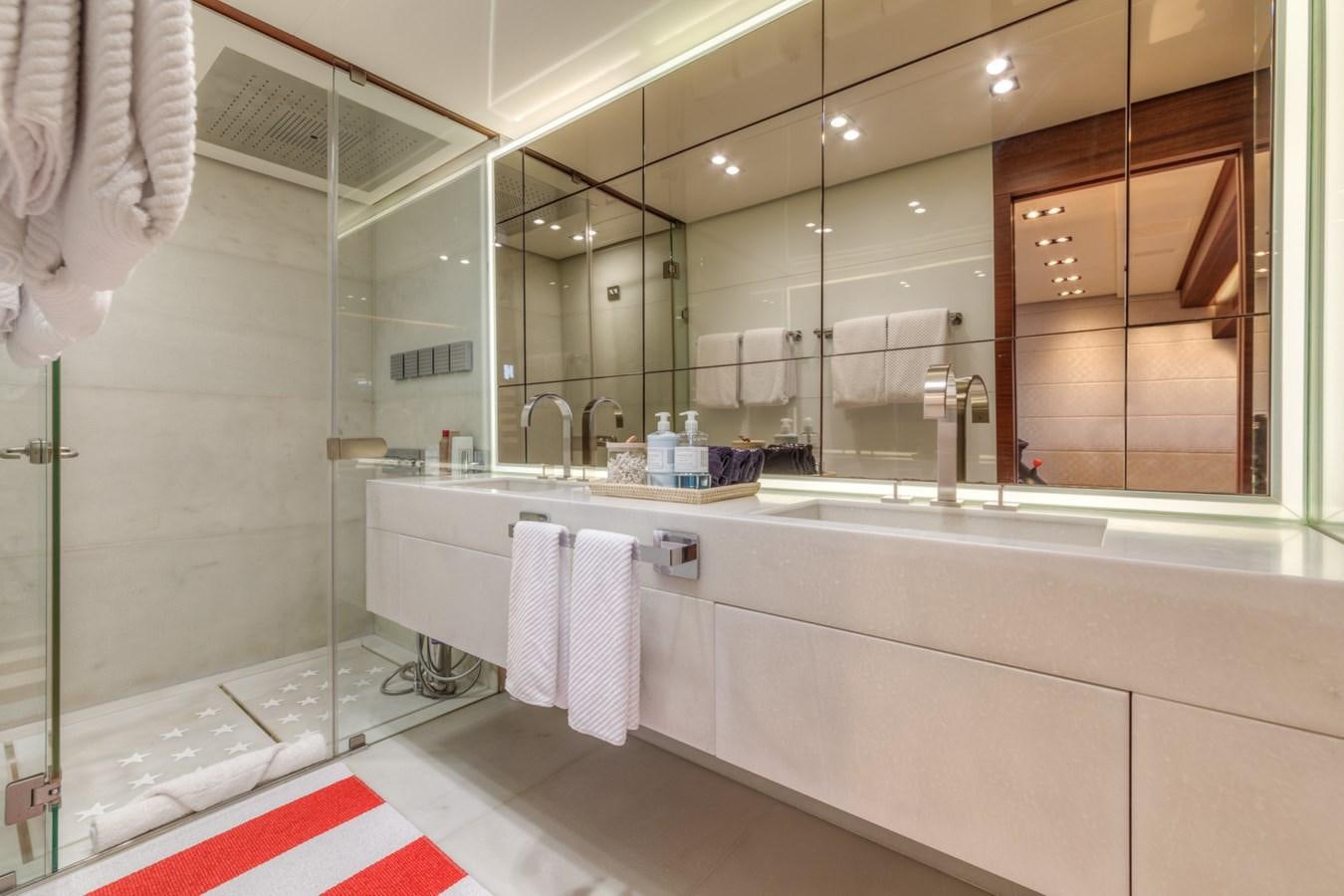 a bathroom with a large mirror aboard PRIMA MEA Yacht for Sale