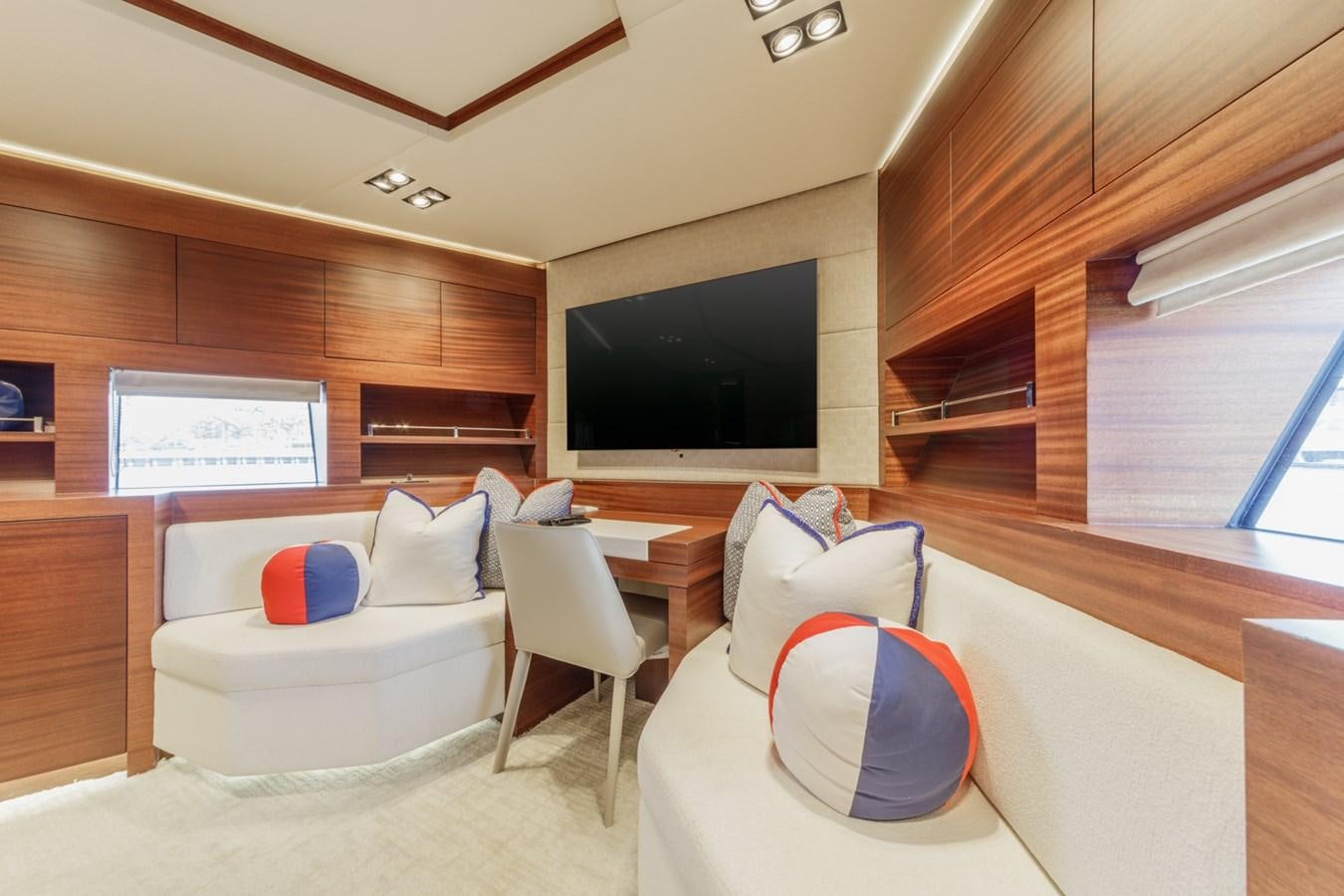 a room with a couch and a tv aboard PRIMA MEA Yacht for Sale