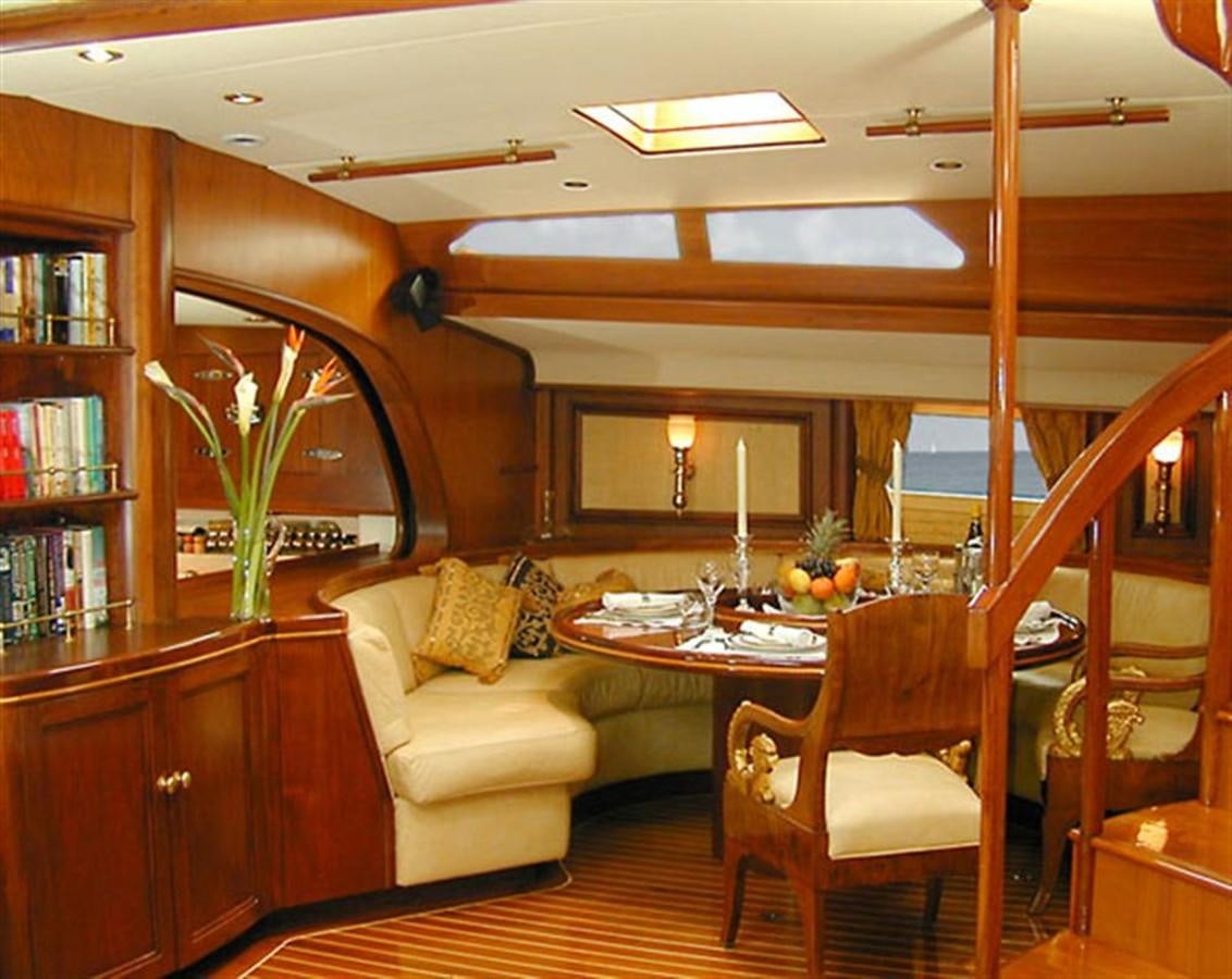 a living room with a table and chairs aboard AURASTEL Yacht for Sale